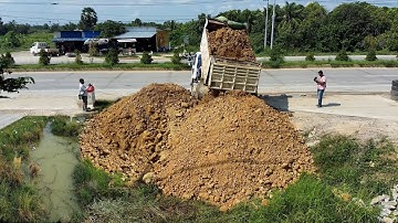 First Start Landfill Work Using KOMATSU D20P Dozer Pushing Stone & Soil with Dump Truck Unloading