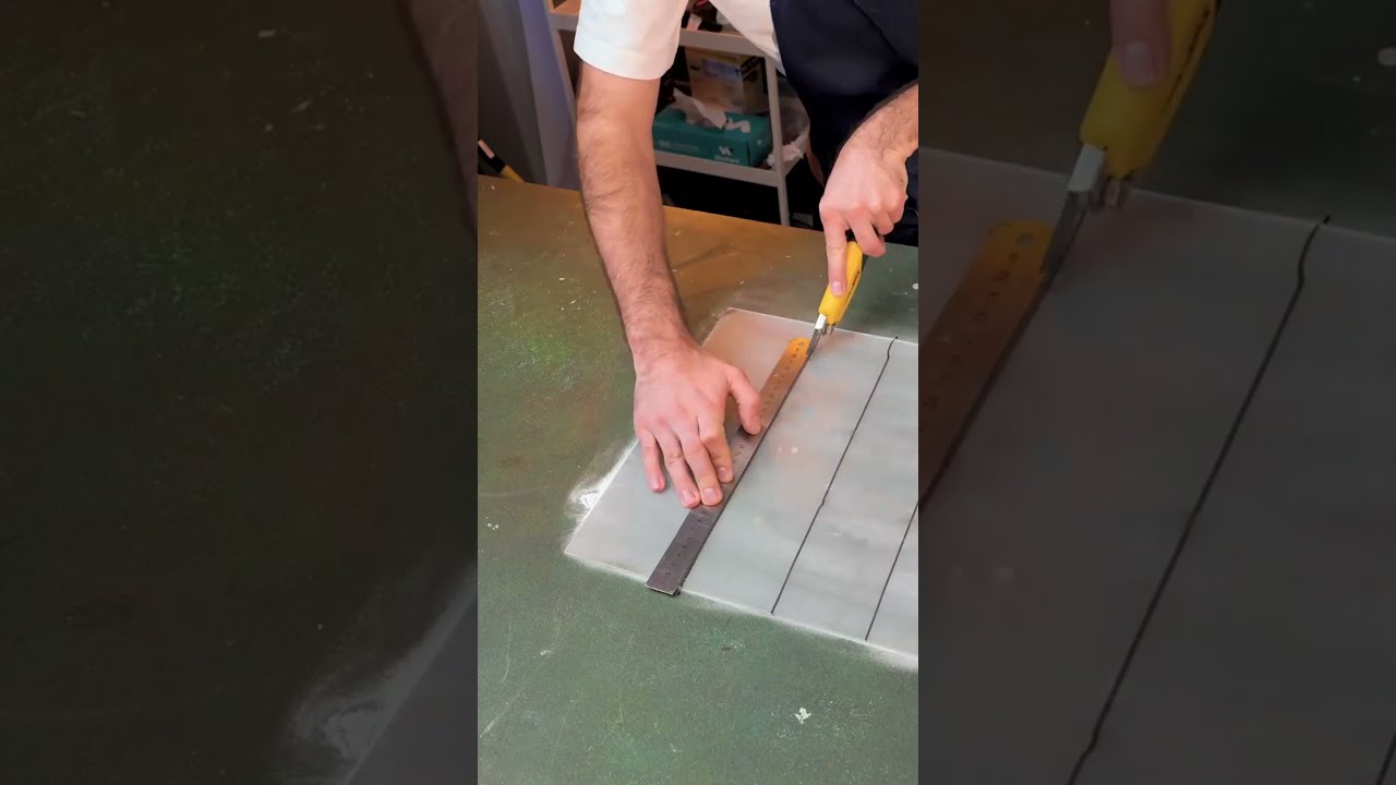 What is he doing with this plexiglass sheet?