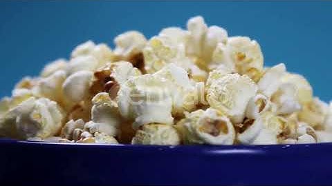 Cooked Popcorn in a Plate on a Blue Background | Stock Footage - Envato elements