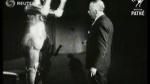 QUIRKY: Captain W.H. Richards displaying metal robot at Wintergarden Exhibition (1930)