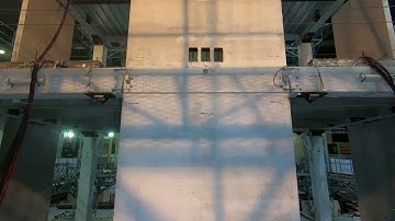 Low-damage concrete building earthquake test: Slotted beam wall joint