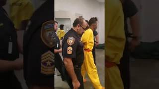 Tavores Henderson led to court in handcuffs belonging to officer he's accused of killing