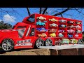 A big red truck that finds a miniature car while running in the park