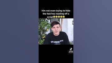 harry walking behind louis in an interview