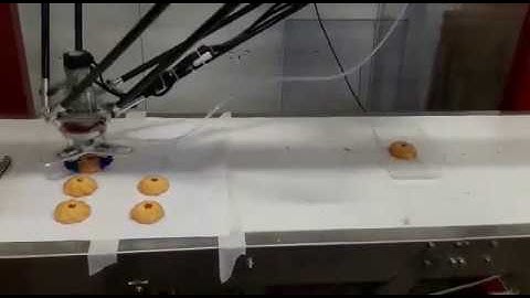 Delta robot grabs cookies into the box