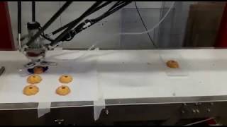 Delta robot grabs cookies into the box