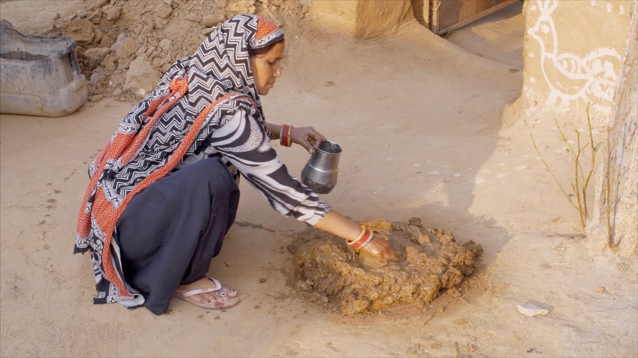 Indian Woman Preparing A Mixture Of Mud And Cow Dung Indian Stock indian-woman-preparing-a-mixture-of-mud-and-cow-dung-indian-stock