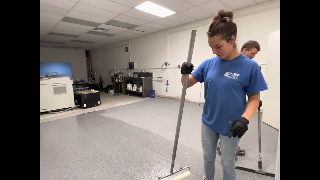 Tile removal, floor leveler added, then epoxy flake system. 
