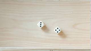 rolling dice on a wooden board with result