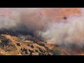 Crews battling brush fire near homes in California