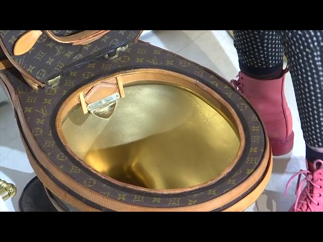 Golden toilet covered in Louis Vuitton m, Stock Video