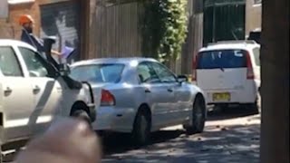 Man throws tiles and chimney off rooftop in Sydney s inner west