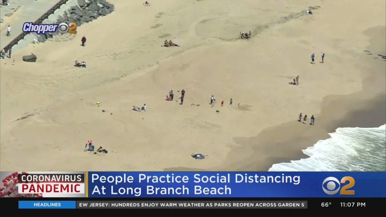 People Practice Social Distancing At Long Branch Beach