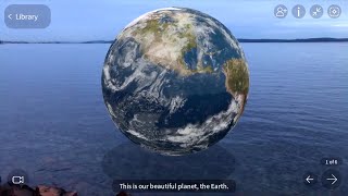 Inside a ‘cgi’ planet earth globe, over flat level water with AR app JigSpace