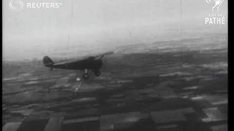 Plane picks up passenger from ground using hook system (1937)