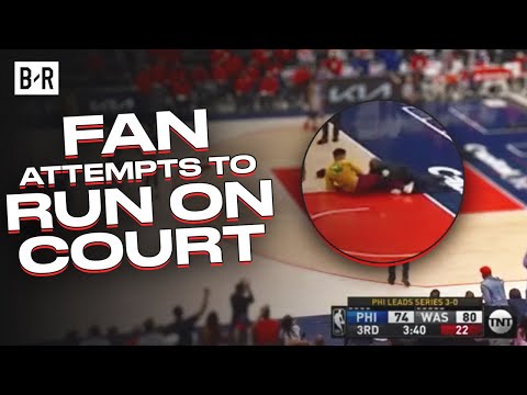 Security Tackles Fan Who Rushes The Court At Wizards-76ers Game