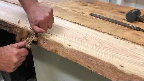 Stripping bark from live edge oak slab with spokeshave