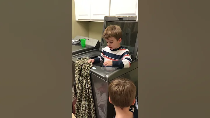 3 year old twins doing laundry from inside machine...