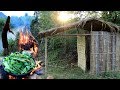 survival in the rainforest - woman cooking snail with Manihot esculenta leaves  - eating delicious