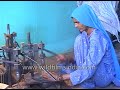 Indian women making rosary beads with machines