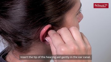 Turn on and insert a custom hearing aid