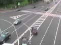 Man with a bucket on his head jumping on black russian VIP car.