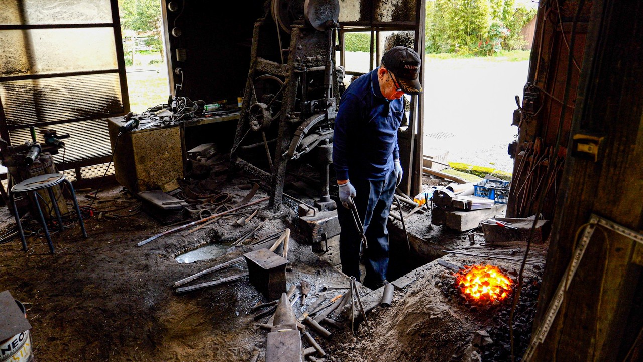 A 76-year-old blacksmith makes hand-forged knives, carrying on a