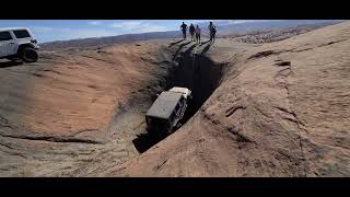 5 Guys attempt to pull Jeep Wrangler up the devils hot tub Moab Utah Hells Revenge