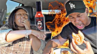 PUTTING THE WORLD'S HOTTEST HOT SAUCE IN MY HUSBAND DONUTS! *INSANE REACTION*