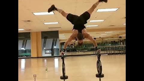 Guy Does Handstand Push-Ups Over Stacked Up Weights - 1145716-3