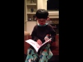 Joshua reading his books