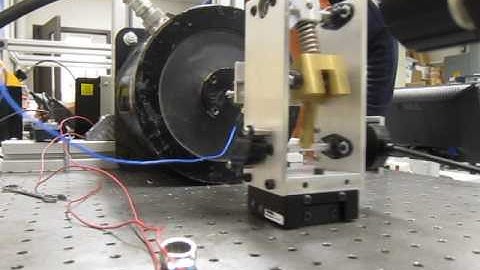 Snap-through dynamics of a rotational bi-stable oscillator