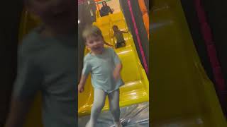 Little girl goes down double yellow slide then falls awkwardly and hits face/head on edge of slide