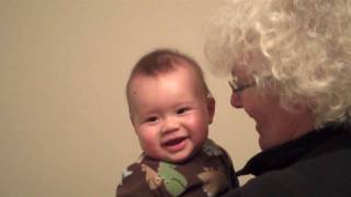 Grandma Martel and Anita tickle Austin's ears with the letter Z