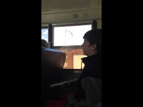 Kid throws book out bus window