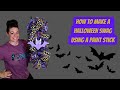 How to make a Halloween swag using a paint stick, mesh, ribbon, and a sign from AtHome.
