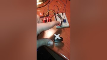 Move a servo and blink a led through a proximity sensor with Arduino