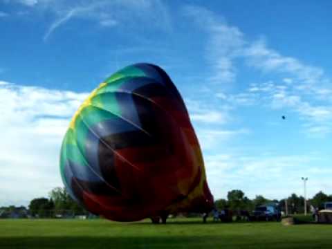 Tequila Sunrise (crewed by Daron-- pilot, Lisa and Dylan Powers) inflates for the crowd in the early morning hours of Saturday June 19, 2010 at the 25th Anniversary of the Monroe Balloon Rally in Monroe Wisconsin.