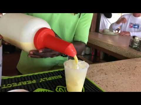 Bartender Glenn teachs Keila how to make a painkiller drink in BVI (English)