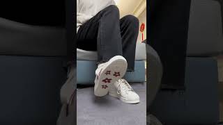 Girl Trying On Sneakers Wearing White Socks And Black Hose On Her Feet