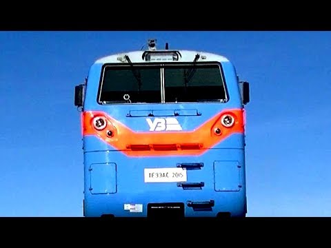 Under diesel locomotive General Electric ТЕ33АС-2015 with freight train