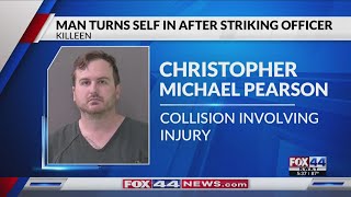 Man charged with hitting police vehicle, injuring officer surrenders