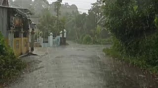 Walking in Heavy Rain on a Bridge Through a Prosperous Indonesian Village