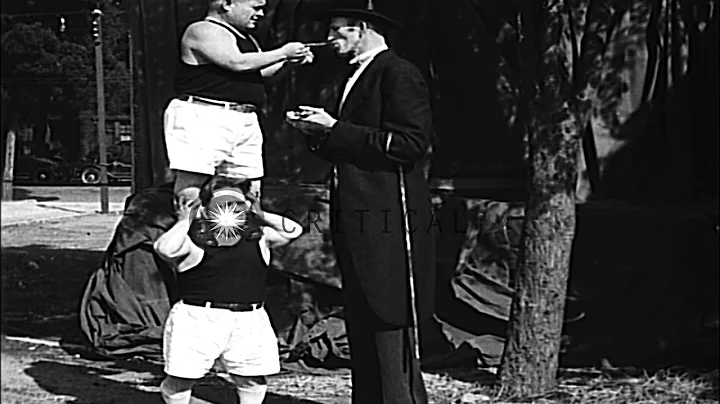 Tall man Ralph Madsen referees a boxing bout betwe...