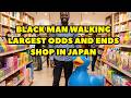 Black man walking in a Japanese mega store