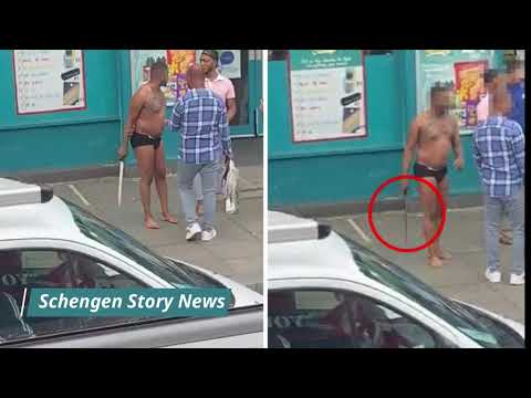 Dramatic moment semi-naked man brandishes SWORD in London street as passer-by tries to disarm him