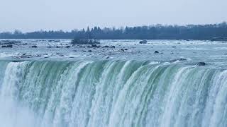 Serene view of Niagara Falls cascading in winter, showcasing natural beauty.
