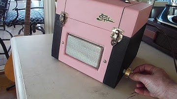 Symphonic 45 RPM portable record player playing a stack of 45