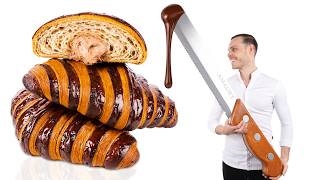 Cutting Open A Giant Chocolate Chip Croissant With A Chocolate Knife