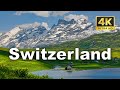 Swiss alps  lush green meadows snow capped peaks and charming chalets